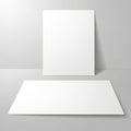 Two blank white papers on gray background Royalty Free Stock Photo