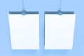 Two blank white posters with binder clip mockup on blue background Royalty Free Stock Photo