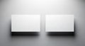 Two blank white rectangular cards on a grey textured wall rectangle Royalty Free Stock Photo