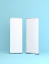 Two Blank White Roll-Up Banners on Light Blue Background Royalty Free Stock Photo