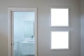 Two blank white square picture/artwork frame mockup template backgrounds on wall at the door of a bathroom/toilet