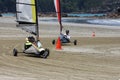 Two blokarts racing on the sand