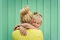 Two blondes Mom and daughter smiling, hugging