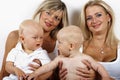 Two blondies women and two babies Royalty Free Stock Photo