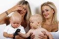 Two blondies women and two babies Royalty Free Stock Photo