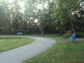 Two blue benches in the park.