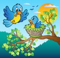 Two blue birds with tree branch