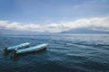 Two blue boats on lake Atitlan with view on volcanic mountainrange in Santa Cruz la Laguna, Guatemala Royalty Free Stock Photo