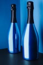 two blue bottles of champagne on blue Royalty Free Stock Photo