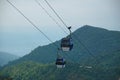 Two blue cable car cabines with a mountain in the background Royalty Free Stock Photo