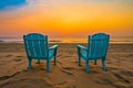 Two blue chairs on the beach at beautiful sunset or sunrise time. Travel content.