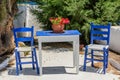 Two blue chairs and a table on a Greek island Royalty Free Stock Photo
