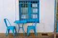 Two blue chairs and a table on the terrace of a restaunte in a typical Mediterranean village Royalty Free Stock Photo
