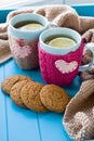 Two blue cup of tea in knitted sweater with hearts felt