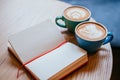 Two cups of cappuccino with notebook