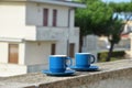 Two blue cups of coffee with panoramic view of a city in background. on the balcony against the backdrop of the old Royalty Free Stock Photo