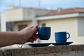 Two blue cups of coffee with panoramic view of a city in background. on the balcony against the backdrop of the old Royalty Free Stock Photo