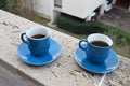 Two blue cups of coffee with panoramic view of a city in background. on the balcony against the backdrop of the old Royalty Free Stock Photo