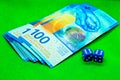 Two blue dices next to money bills with a green background Royalty Free Stock Photo