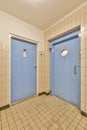 two blue doors in a bathroom in a public restroom Royalty Free Stock Photo