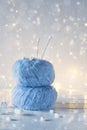 Two blue fluffy ball yarn and knitting needles.