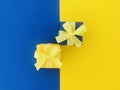 Two Blue gift boxes on half yellow and blue background.