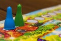 Two blue and green board chips for a children`s board game on a bright background.