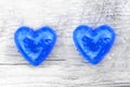 Two blue hearts on natural wooden background as loving heart symbol for wedding greeting card with heart symbol or Valentine`s Day Royalty Free Stock Photo