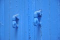 Two blue knockers hand design, Tunisian blue door Royalty Free Stock Photo