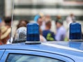 Two blue lights siren of a police car and many people Royalty Free Stock Photo