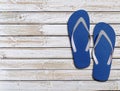 Two blue man lifestyle relax flip flops on white wooden floor Royalty Free Stock Photo