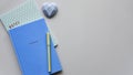 Two blue notepads with pen on a blue paper background. Top view. Flat lay.