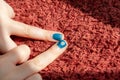 Two blue painted fingernails with flower and eye details