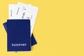 Two blue passports, boarding pass yellow background closeup top view, flight ticket, airplane travel concept,  summer holidays Royalty Free Stock Photo