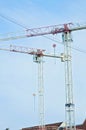 Two blue and red colored crane machines against a blue sky. Building site or construction site in Budapest, Hungary, Europe. Royalty Free Stock Photo