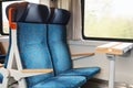 Two blue seats and a desk with an electric drawer in the interior of train in the Czech Republic, Europe Royalty Free Stock Photo