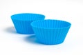 Two blue silicone molds for baking a cupcake on a white background Royalty Free Stock Photo