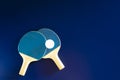 Two blue tennis rackets with white ball on it Royalty Free Stock Photo