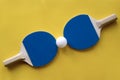 Two blue tennis rackets with white ball on it Royalty Free Stock Photo