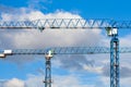 Two blue tower cranes against a cloudy sky Royalty Free Stock Photo
