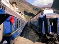 Two blue trains parked at the Machu Picchu train station, Peru