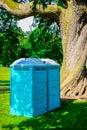 Two blue - white portable toilet cabins at outside event UK Royalty Free Stock Photo