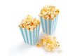 Two blue white striped carton buckets with tasty cheese popcorn, isolated on white background Royalty Free Stock Photo