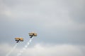 Two Blue and Yellow Biplanes Flying, Together Upwards Royalty Free Stock Photo