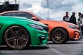 Two BMW M3 F80 cars wrapped in chrome and matte vinyls and equipped with wide body kits and custom forged wheels Royalty Free Stock Photo