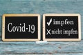 Two boards with the inscription Covid-19 vaccinate or not vaccinate Royalty Free Stock Photo