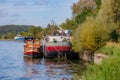 Two boats anchored at a dock berth on Albert Canal, cargo ship in background Royalty Free Stock Photo