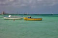 Two boats anchored near the beach on the Caribbean sea. Royalty Free Stock Photo