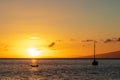 Two boats anchored in the Pacific Ocean during a beautiful, bright sunset Royalty Free Stock Photo