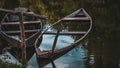 two boats half submerged in water reflect sky trees Royalty Free Stock Photo